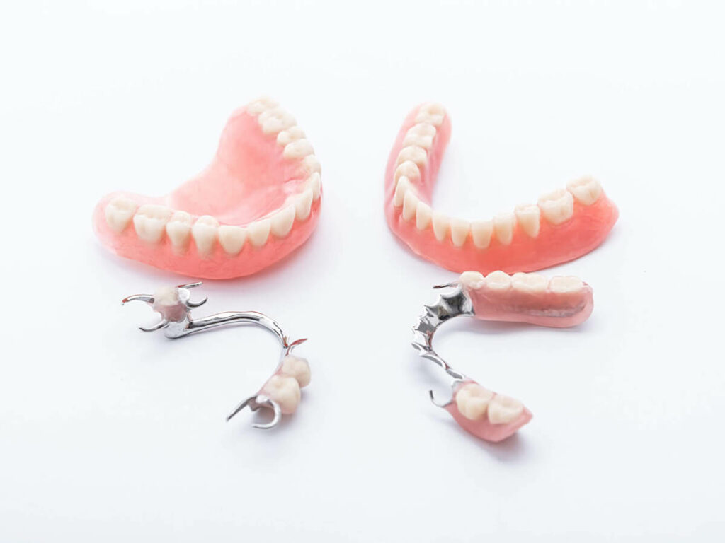 Full, partial and removable dentures sitting on table