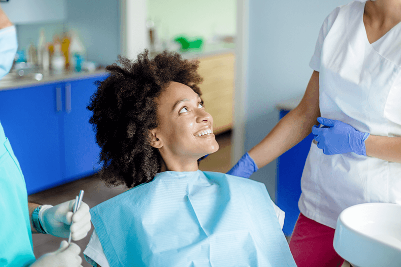 Woman smiling at dentist during her appointment